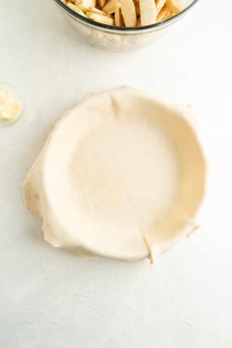 An untrimmed pie pastry in a pie plate.