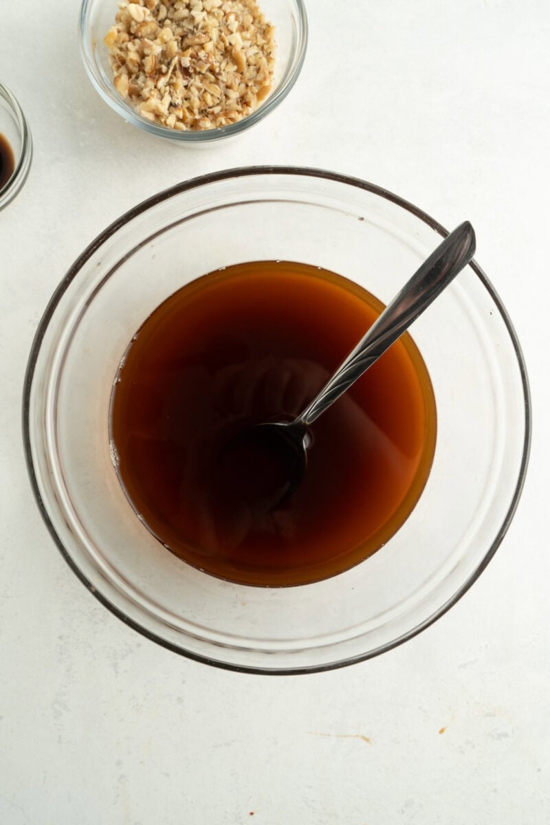 A bowl of sugar and coffee being mixed.